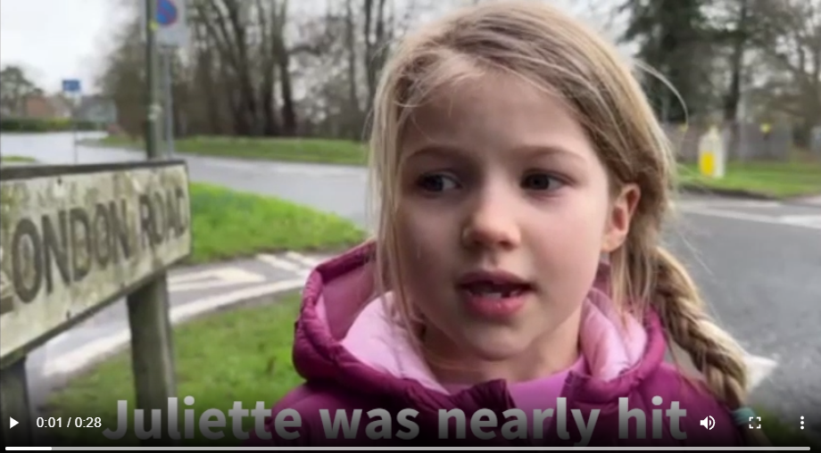 Young girl standing beside a road